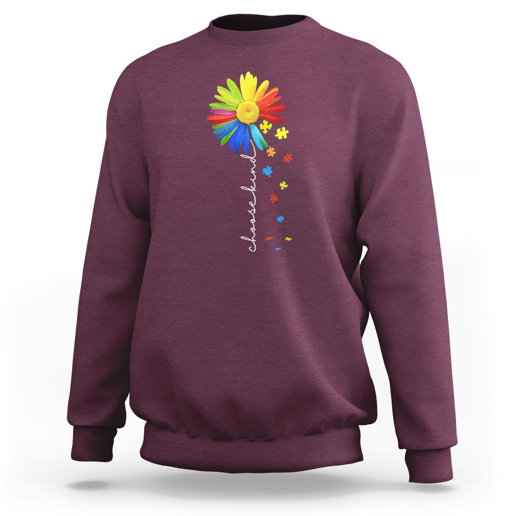 Maroon crewneck sweatshirt with colorful sunflower and rainbow puzzle graphic on chest