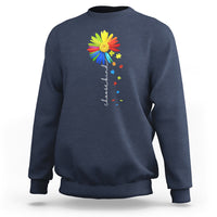 Navy crewneck sweatshirt with colorful sunflower and rainbow puzzle graphic on chest
