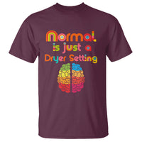 Maroon autism awareness T-shirt with rainbow “Normal is Just a Dryer Setting” brain graphic