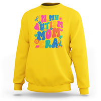 Yellow autism mom sweatshirt with colorful autism text and puzzle graphic