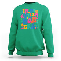 Green autism mom sweatshirt with colorful autism text and puzzle graphic