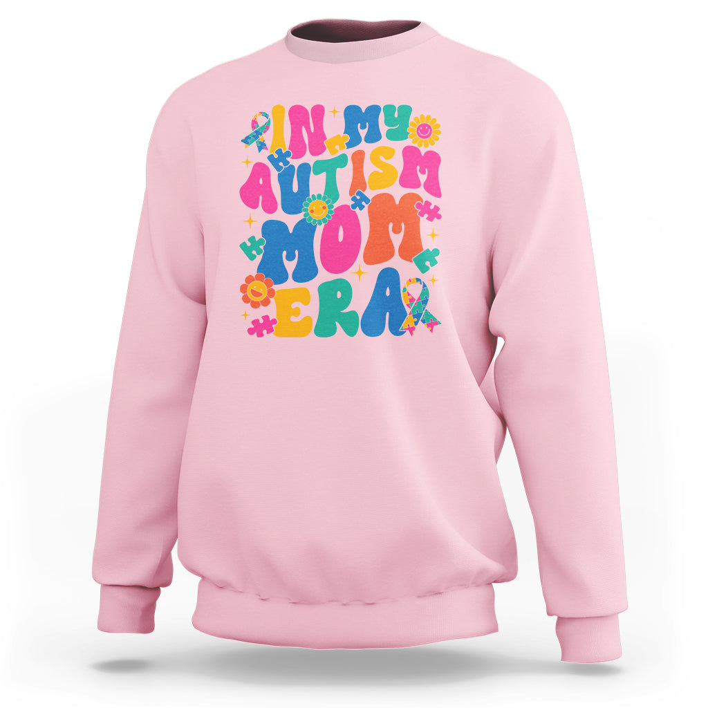 Light pink autism mom sweatshirt with colorful autism text and puzzle graphic