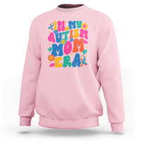 Light pink autism mom sweatshirt with colorful autism text and puzzle graphic