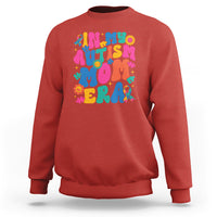 Red autism mom sweatshirt with colorful autism text and puzzle graphic