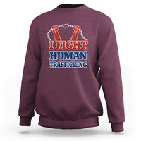 Maroon sweatshirt with 'I FIGHT HUMAN TRAFFICKING' graphic and fist chain
