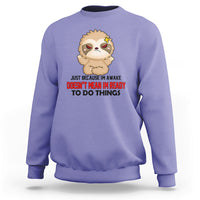 Violet sweatshirt with cartoon sloth face and bold slogan graphic, crewneck pullover