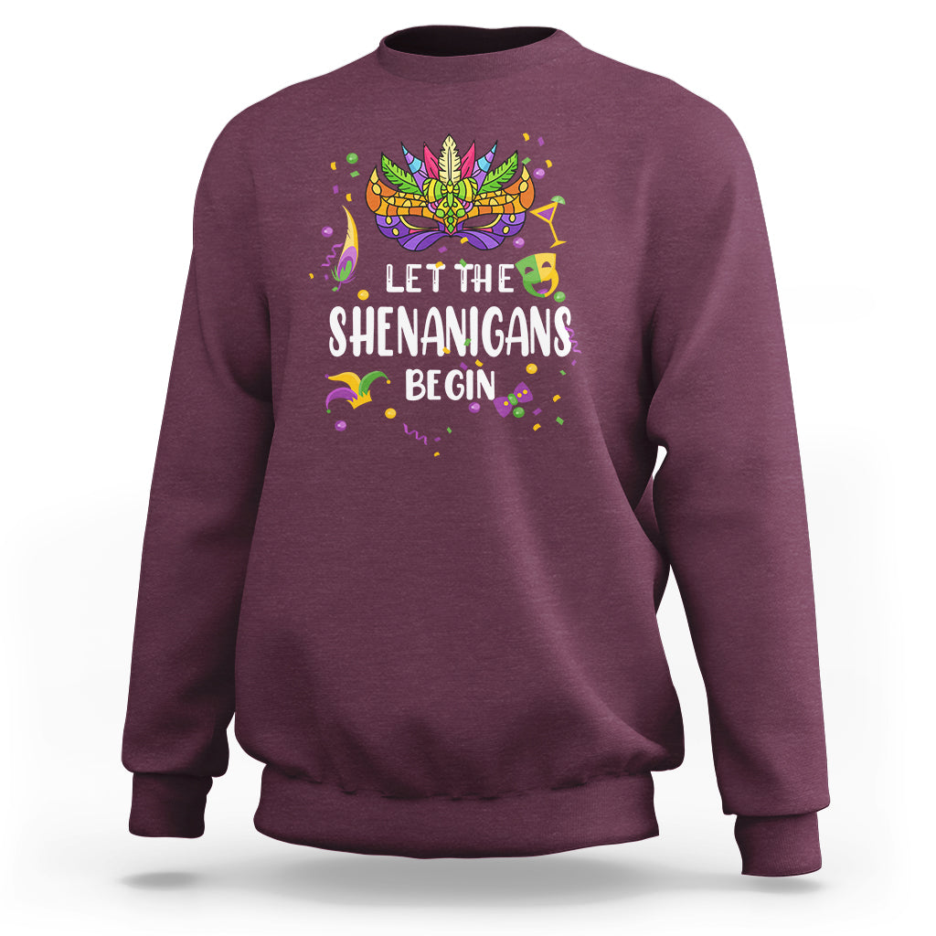 Women’s maroon sweatshirt with colorful Mardi Gras mask and “Let the Shenanigans Begin” text