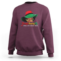 Women's maroon crewneck sweatshirt with colorful Juneteenth graphic and “Free-ish since 1865”