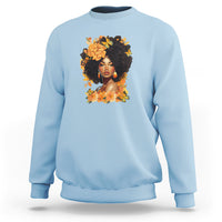 Light blue crewneck sweatshirt with front portrait graphic and floral wreath