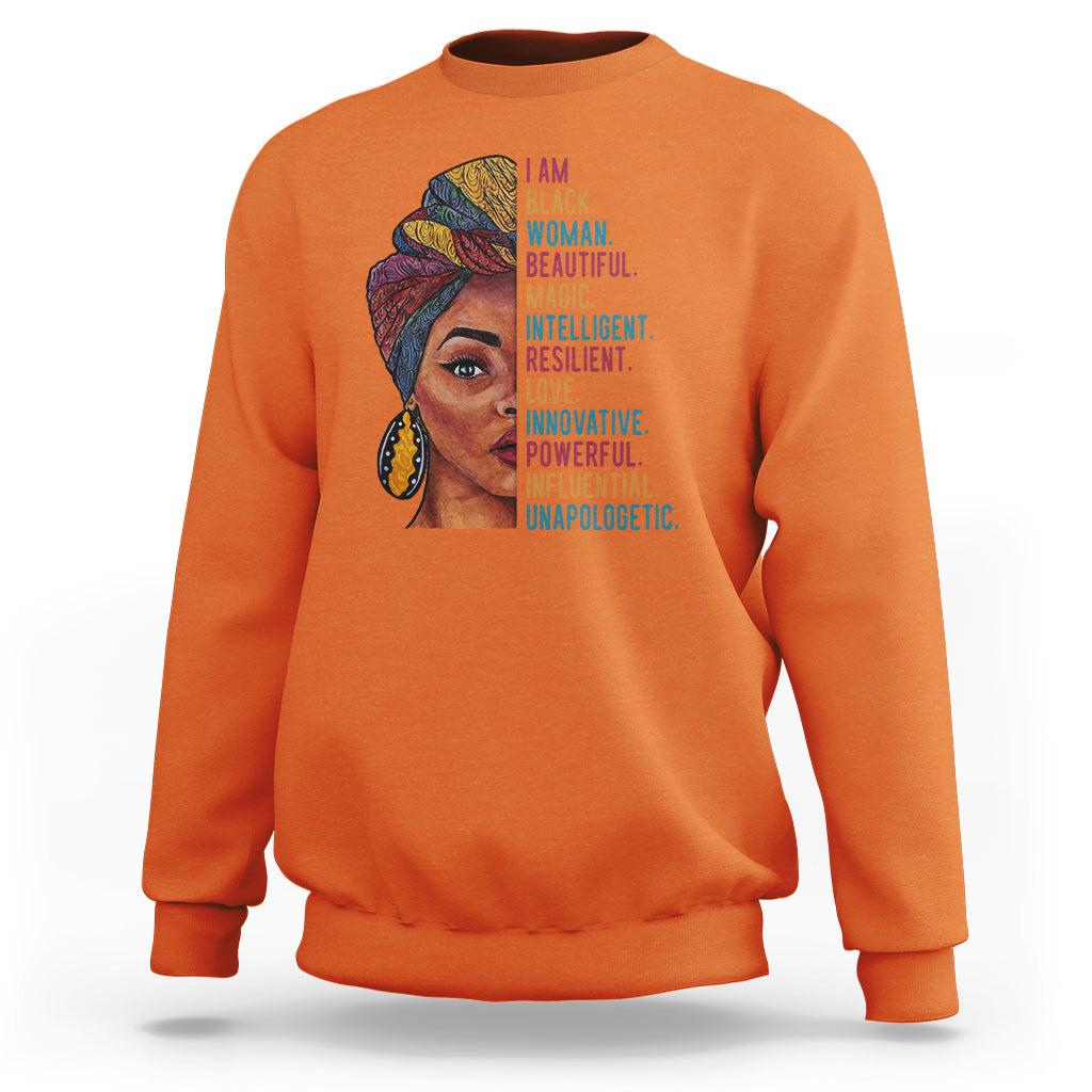 Orange crewneck sweatshirt with woman face graphic and vertical inspirational text.