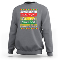 Dark heather gray crewneck sweatshirt with colorful Juneteenth Believe Achieve graphic on front