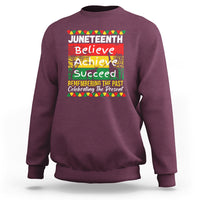Maroon crewneck sweatshirt with colorful Juneteenth Believe Achieve graphic on front