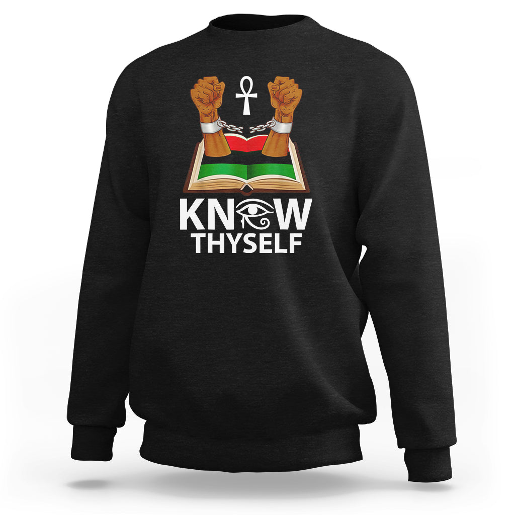 Black crewneck sweatshirt with 'KNOW THYSELF' graphic: open book, cross, raised hands