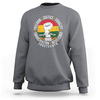 Dark heather gray crewneck sweatshirt with colorful Juneteenth fist graphic on back
