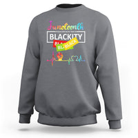 Light gray crewneck sweatshirt with “Juneteenth Blackity” graphic and colorful heartbeat line