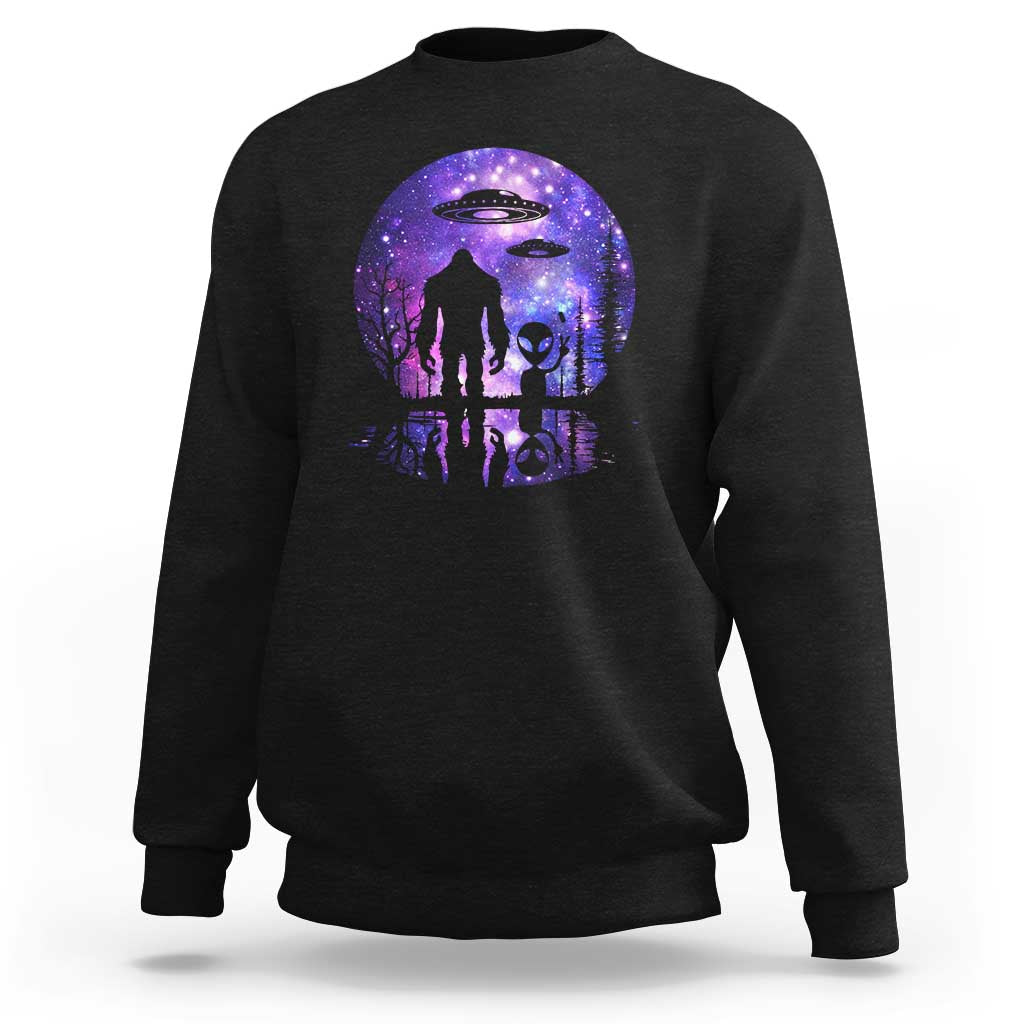 Crewneck sweatshirt in black with galaxy full-moon alien and Bigfoot UFO graphic.