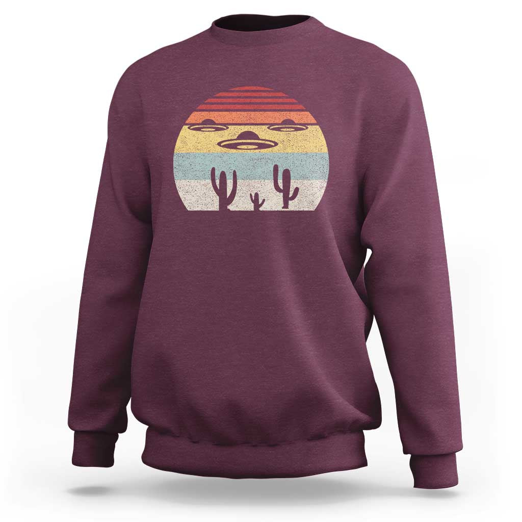 Maroon crewneck sweatshirt with vintage UFO and alien graphic on chest