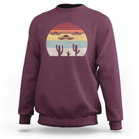 Maroon crewneck sweatshirt with vintage UFO and alien graphic on chest