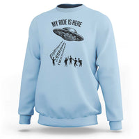 Light blue crewneck sweatshirt with alien UFO graphic and abduction silhouettes