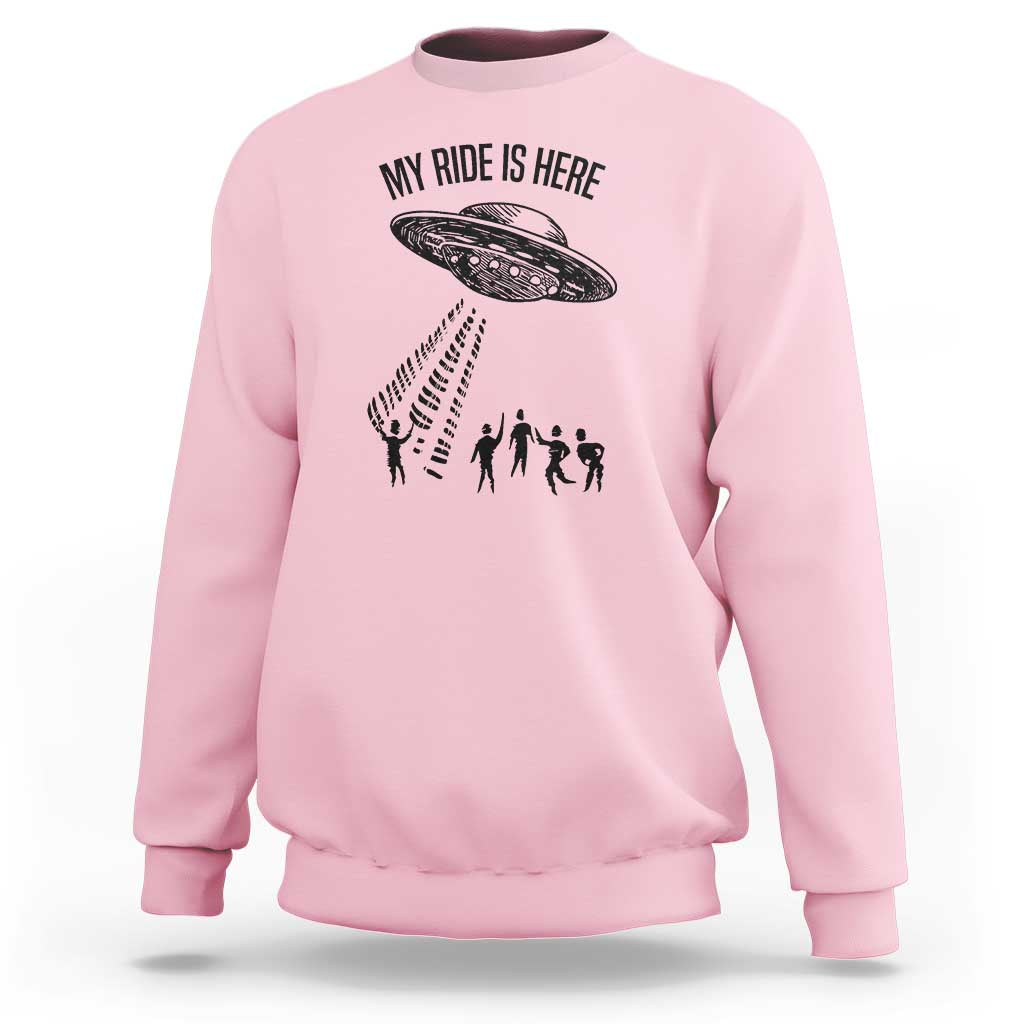 Light pink crewneck sweatshirt with alien UFO graphic and abduction silhouettes