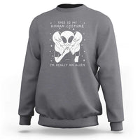 Charcoal gray crewneck sweatshirt with alien face graphic and “I’m really an alien” print.