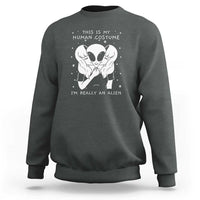 Dark heather crewneck sweatshirt with alien face graphic and “I’m really an alien” print.