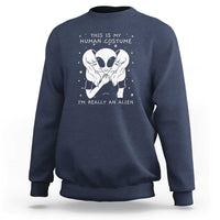Navy crewneck sweatshirt with alien face graphic and “I’m really an alien” print.