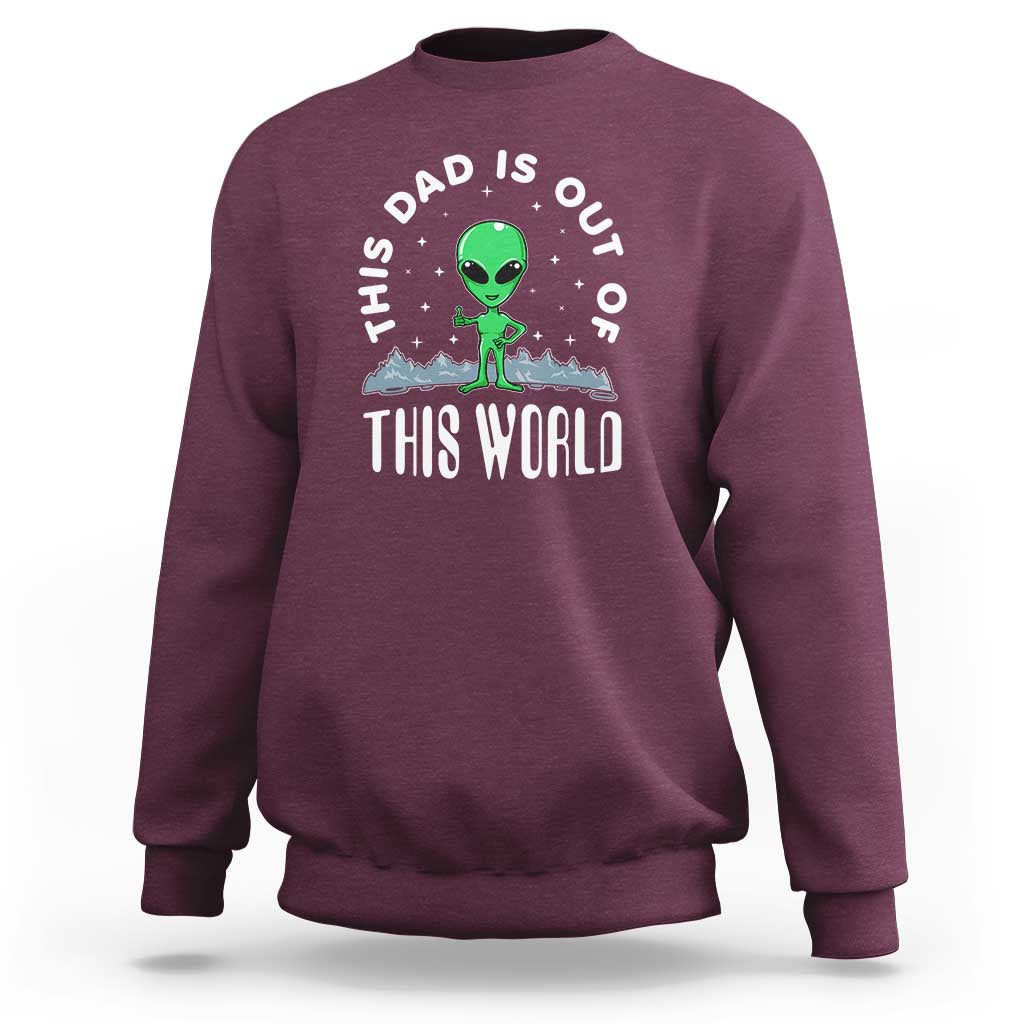 Maroon dad-style sweatshirt with alien graphic and 'THIS WORLD' front print