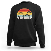 Black crewneck sweatshirt with desert alien UFO graphic