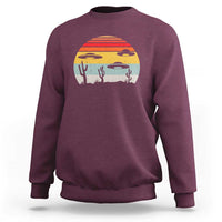 Maroon crewneck sweatshirt with desert alien UFO graphic
