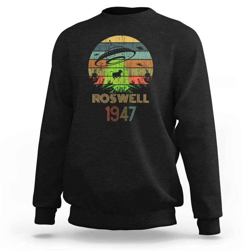 Black crewneck sweatshirt with “Roswell 1947” alien abduction graphic on front