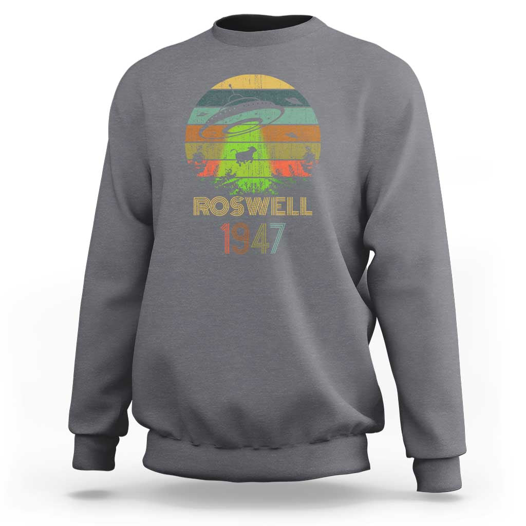 Light gray crewneck sweatshirt with “Roswell 1947” alien abduction graphic on front