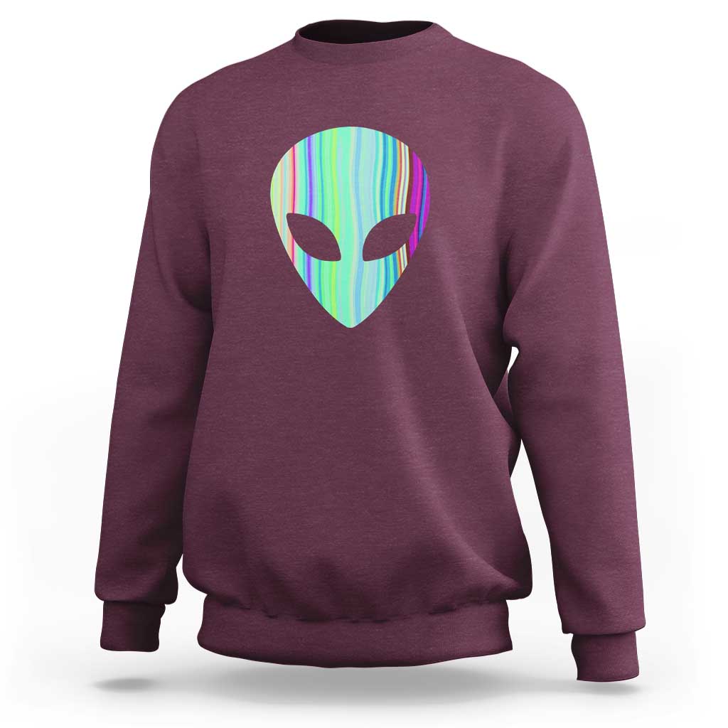 Maroon crewneck sweatshirt with holographic alien head graphic at the chest