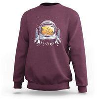 Maroon crewneck sweatshirt with astronaut graphic on chest