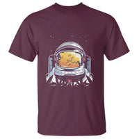 Maroon crew-neck T-shirt with astronaut face graphic on the chest