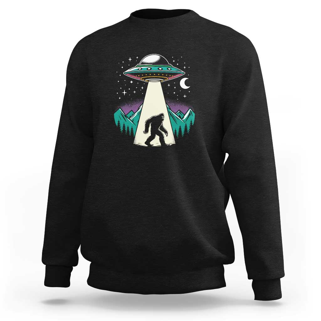 Black crewneck sweatshirt with UFO and Bigfoot graphic on chest