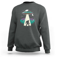 Gray crewneck sweatshirt with UFO and Bigfoot graphic on chest