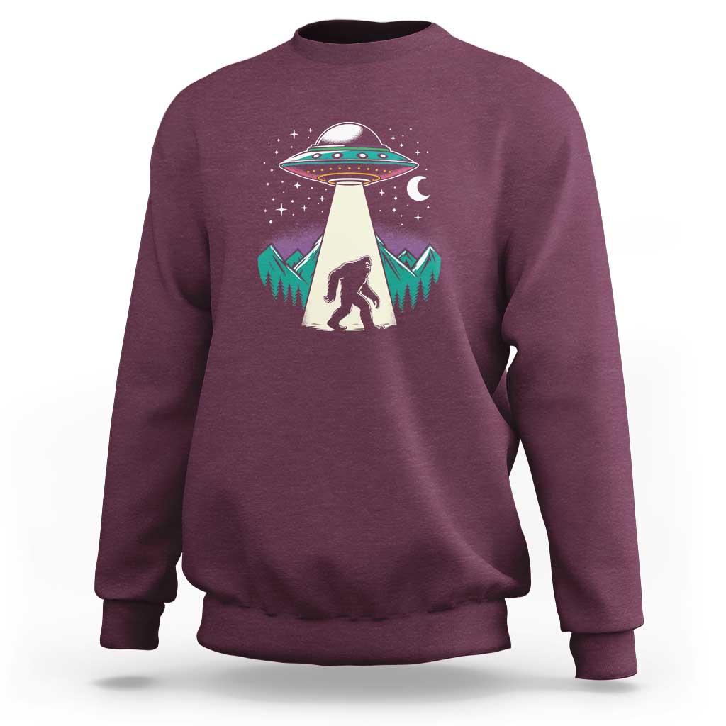 Maroon crewneck sweatshirt with UFO and Bigfoot graphic on chest