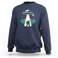 Navy crewneck sweatshirt with UFO and Bigfoot graphic on chest