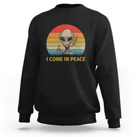 Black crewneck sweatshirt with alien holding a peace sign and "I COME IN PEACE" graphic