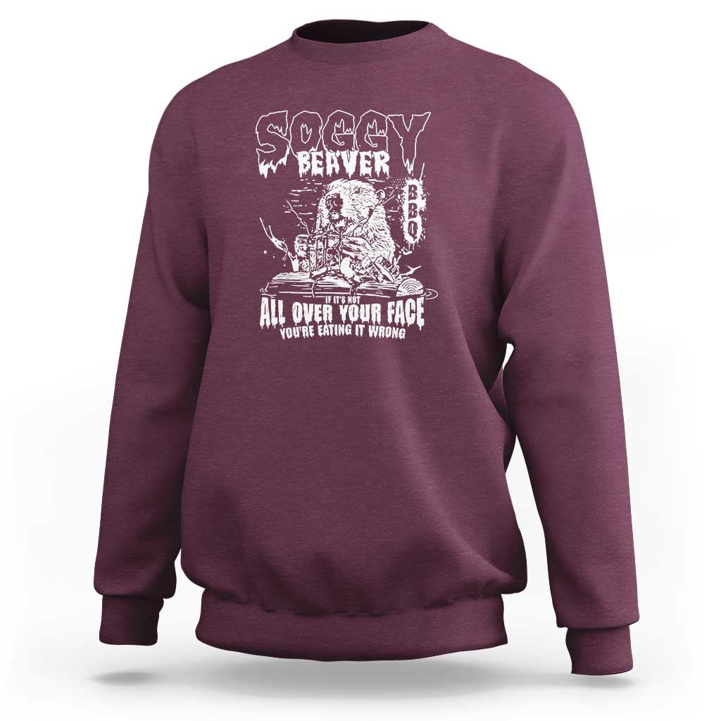 Maroon crewneck sweatshirt with white beaver face graphic and All over your face text