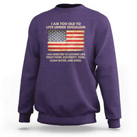 Purple crewneck sweatshirt with front graphic featuring a U.S. flag and slogan text