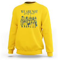Women's rights sweatshirt, daisy yellow with blue We Are Not front graphic