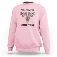 Light pink sweatshirt with floral graphic and text 'roe, roe, roe' and 'your vote'.