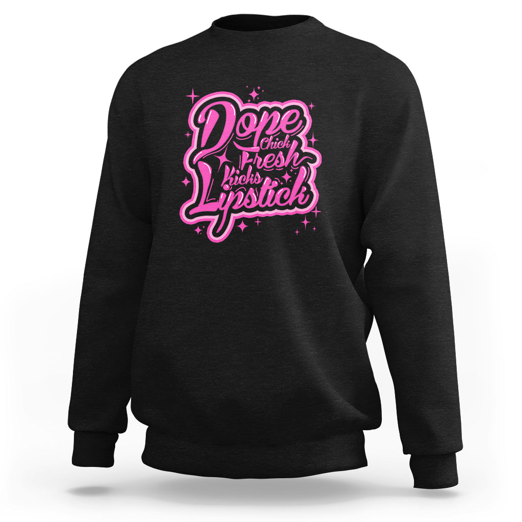 Black crewneck sweatshirt with pink “Dope Chick Fresh Lipstick” graphic on chest
