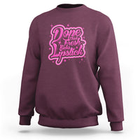 Maroon crewneck sweatshirt with pink “Dope Chick Fresh Lipstick” graphic on chest