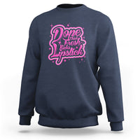 Navy crewneck sweatshirt with pink “Dope Chick Fresh Lipstick” graphic on chest