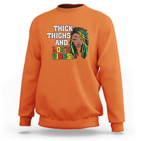 Orange crewneck sweatshirt with 'THICK THIGHS AND LOC'D VIBES' front graphic