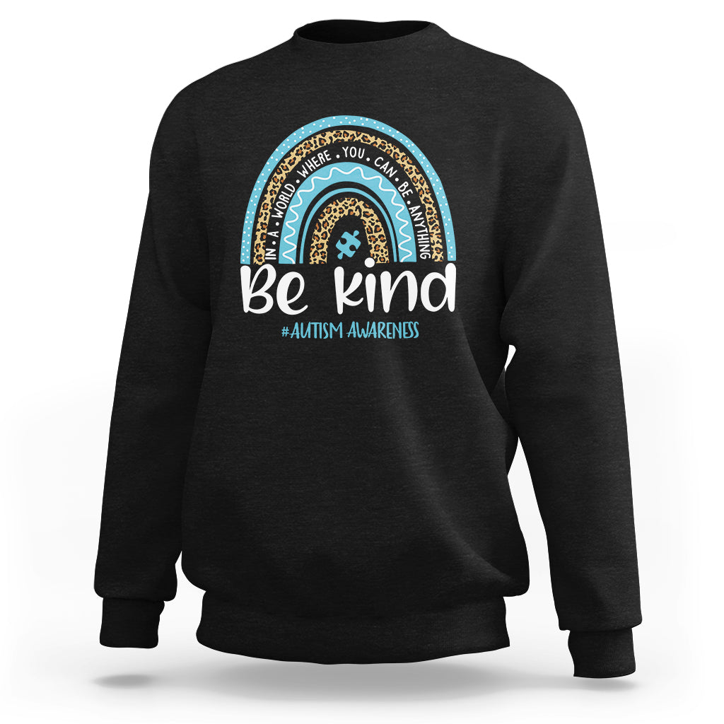 Black unisex sweatshirt with "Be kind" autism awareness rainbow graphic