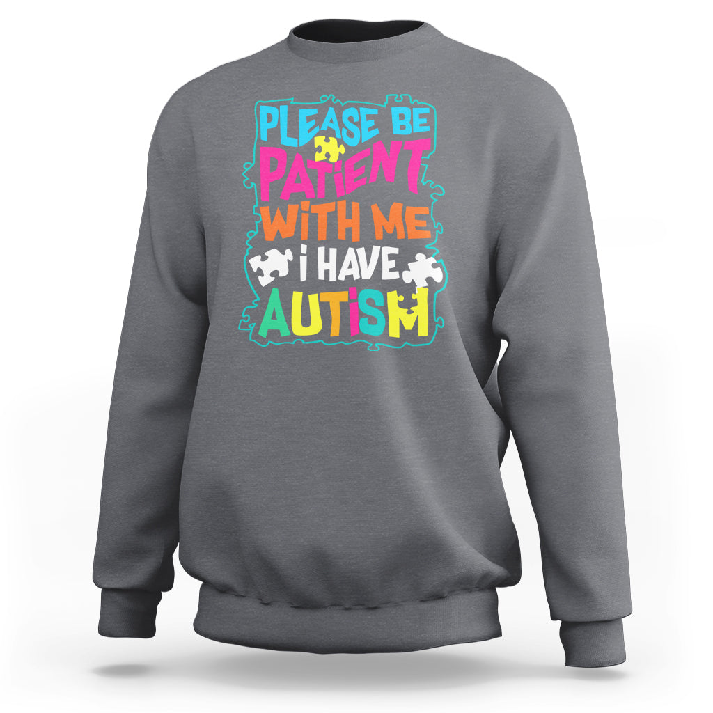 Dark heather gray autism sweatshirt with colorful “Please be patient with me” graphic